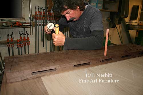 Earl pegging tenons at one end of custom made dining table